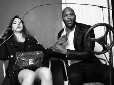 A man and woman sitting together, engaged in conversation.