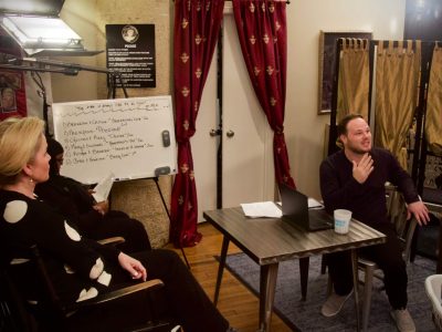 Two people discussing in a small studio
