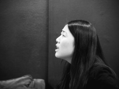 Black-and-white profile of woman speaking