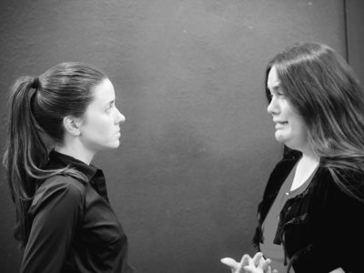 Black-and-white photo of two women talking